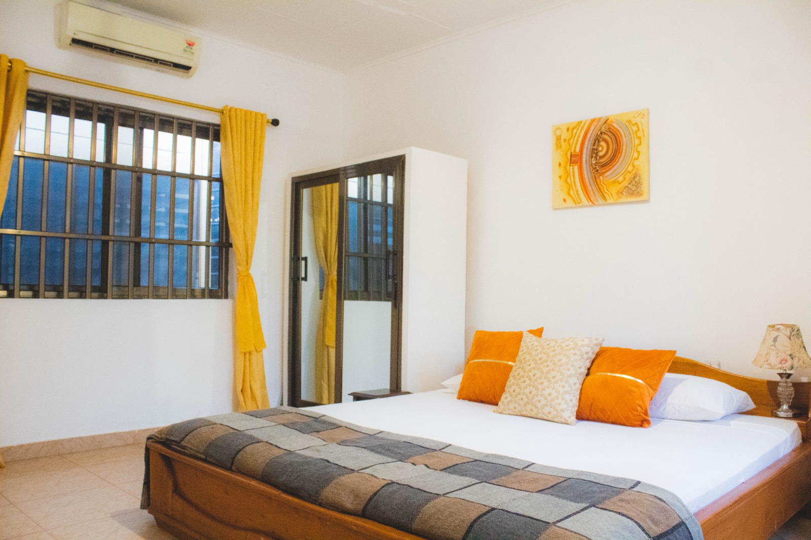 The bedroom is bright and clean, with a splash of colour.